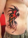 tribal phoenix picture tattoo on rib